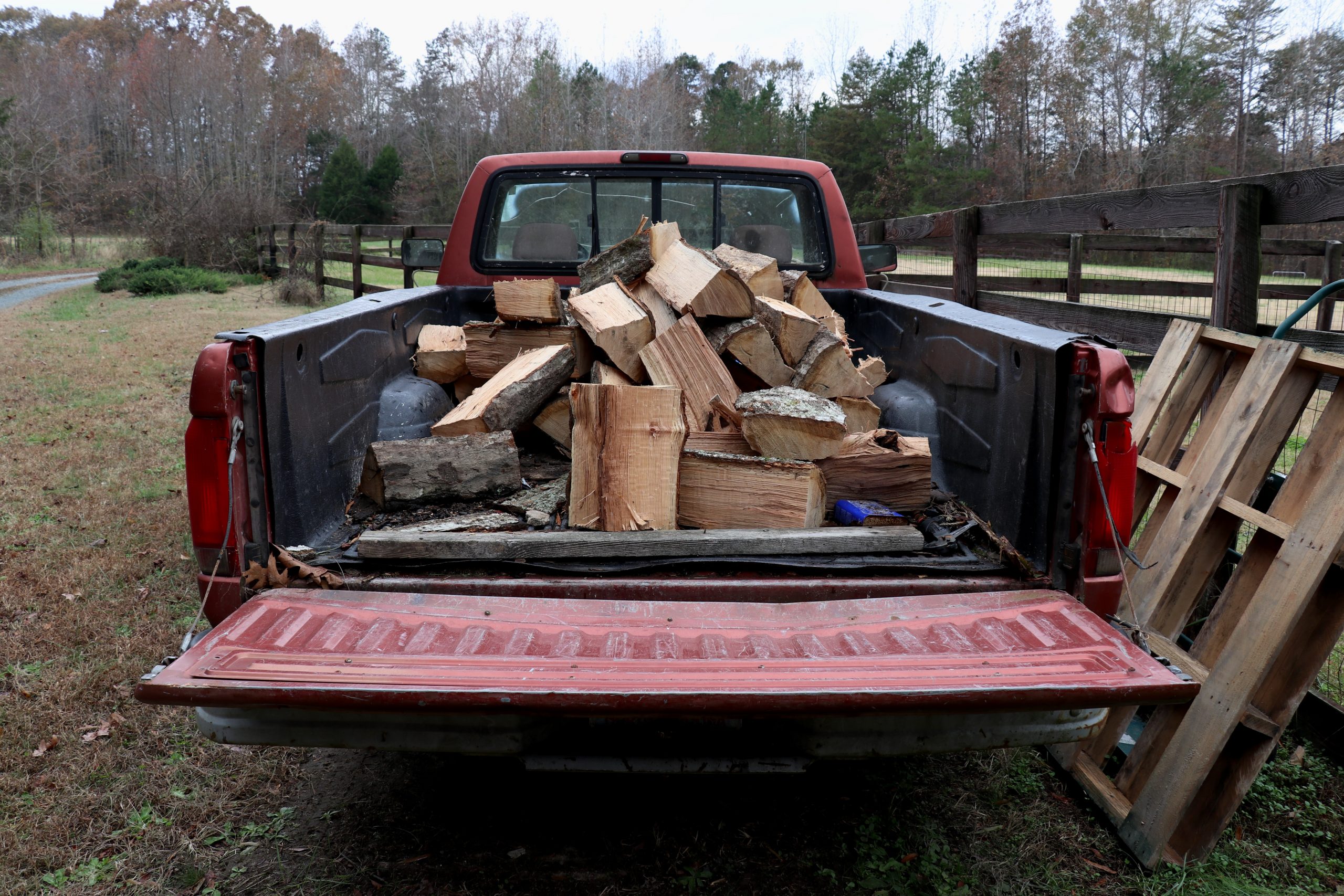 Red truck with firewood in the back
