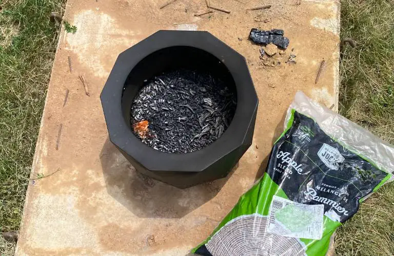 a bag of Oklahoma Joe's pellets next to a smokeless fire pit