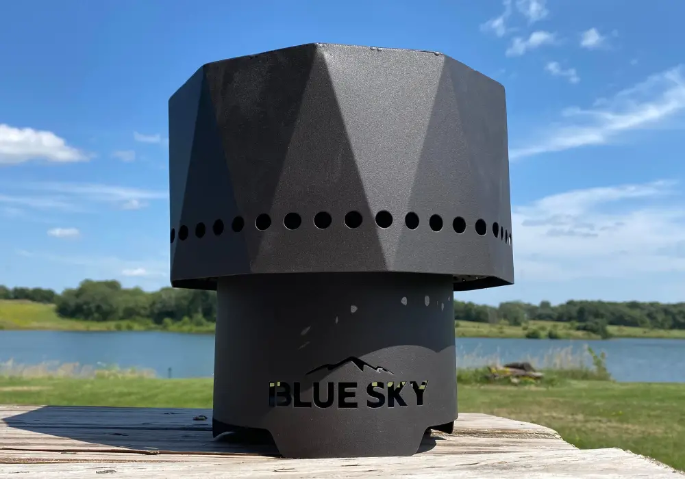 blue sky pike ultra portable smokeless fire pit in front of a lake