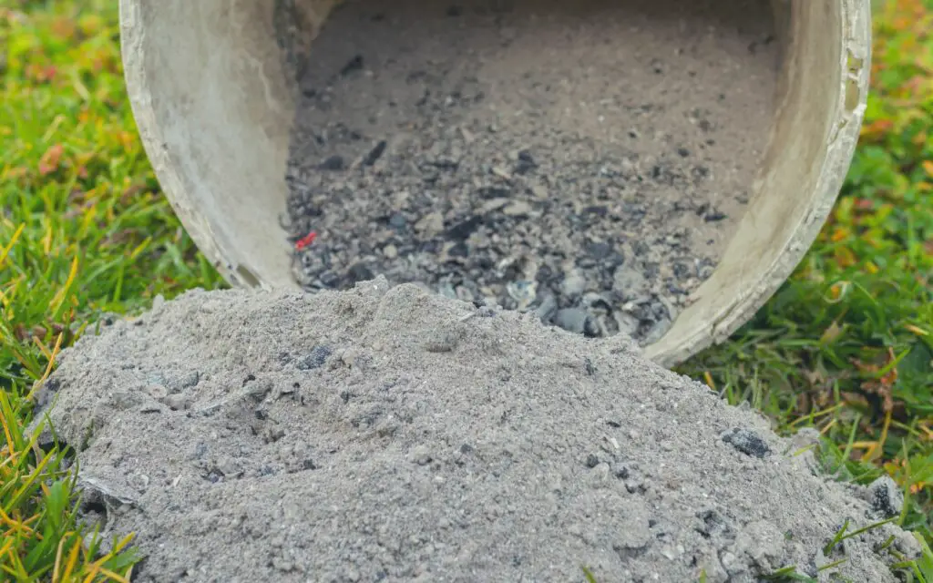 dumping a bucket of ash in the grass