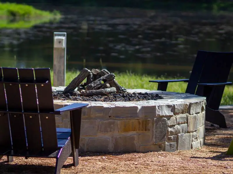 diy fire pit with chairs sitting around it