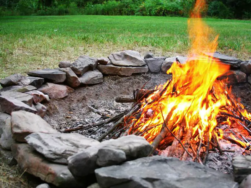 a stone fire pit burning