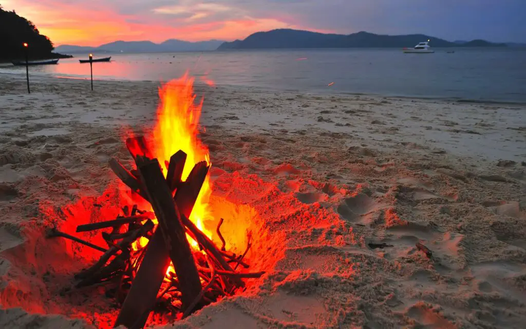 a campfire on the beach