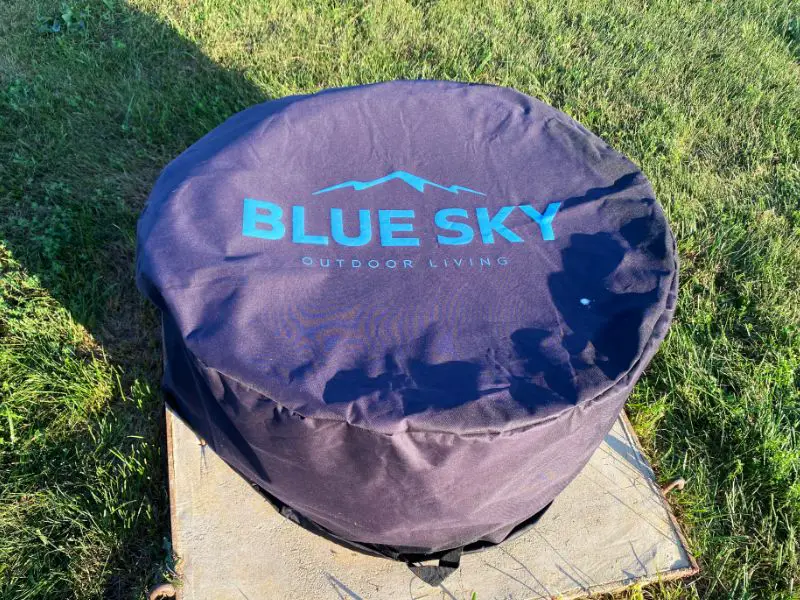 The Mammoth blue sky fire pit with the protective cover accessory over it