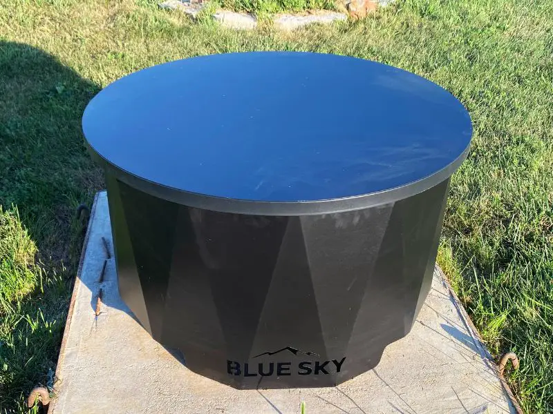 A blue sky outdoor living accessory that turns this patio fire pit into a coffee table