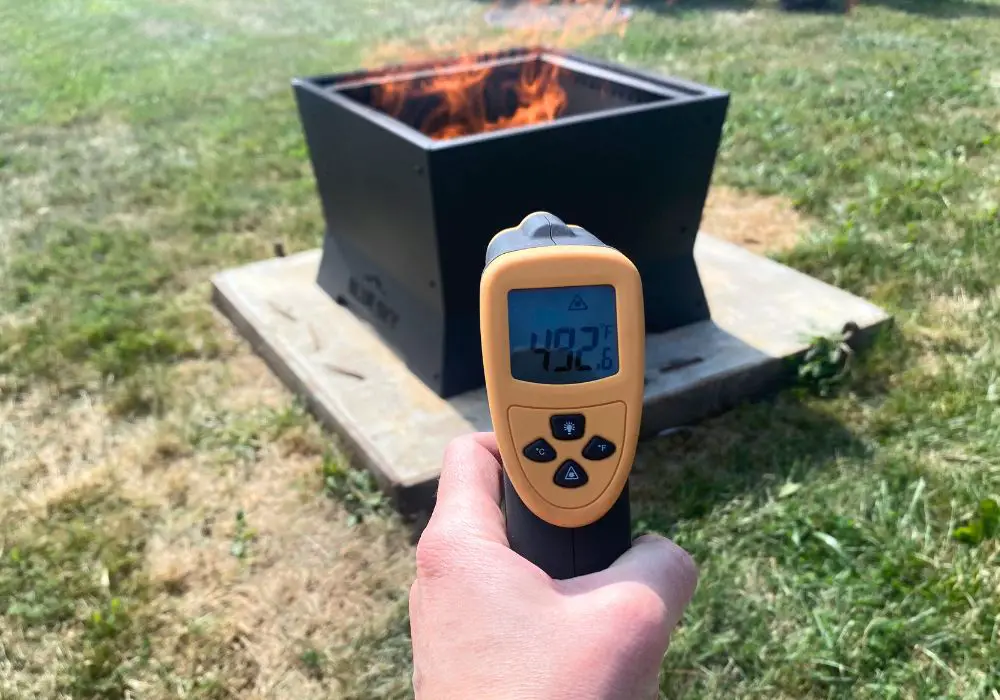 infrared thermometer showing that the outside of the fire pit is 492 degrees